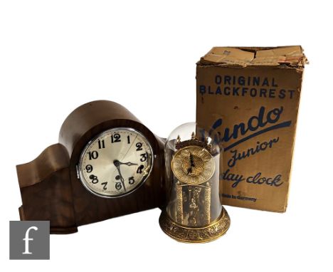 A Kundo Junior 400 day mantle clock in glass dome and original printed cardboard box and a walnut cased mantle clock. (2) 