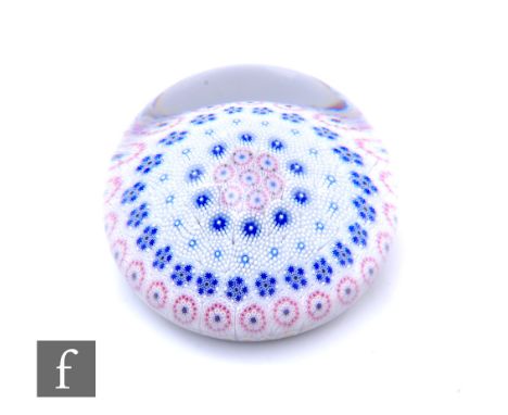 A contemporary Twists Glass paperweight, designed by Mike Hunter, of domed form and internally decorated with concentric circ