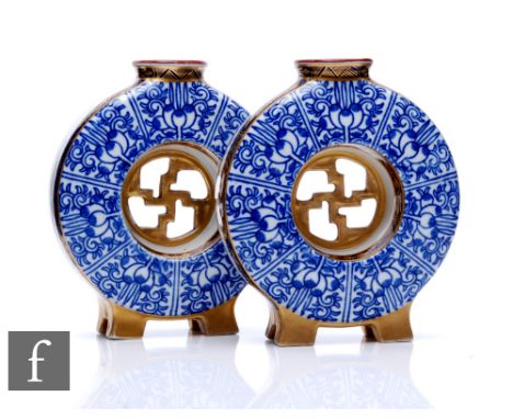 A pair of Royal Worcester 'Royal Lily' posy flasks, circa 1885, each of circular moonflask form, with central moulded gilt ce