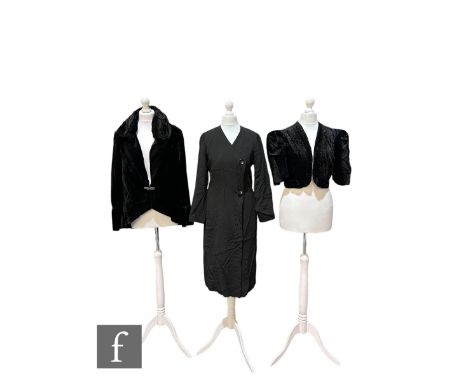 A 1930s vintage black velvet evening jacket, with ruched collar, long sleeves and flared cuffs, fastened with a diamante clip