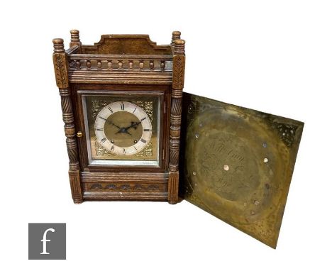 A late Victorian oak mantle clock, eight day striking movement, the square brass dial enclosed by a glazed door within a gall