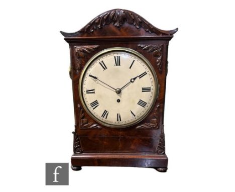 A 19th Century William IV mahogany bracket clock, single fusee movement circular dial within a brass bezel, scroll carved dec