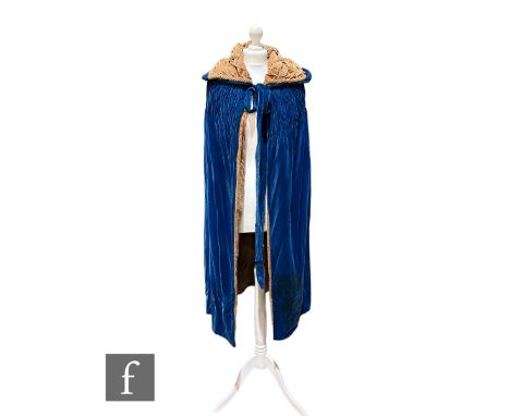A 1920s/30s vintage blue velvet cloak, with tan velvet interior, ruched shoulder and collar detail and tie front. 