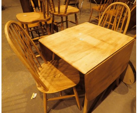 Ercol splay leg dropleaf table with two Ercol stickback chairs