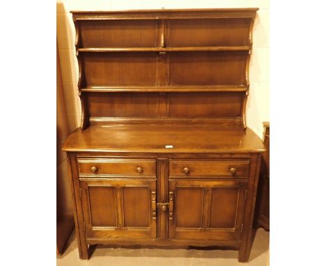 Medium ash Ercol dresser with two drawers over two cupboards 