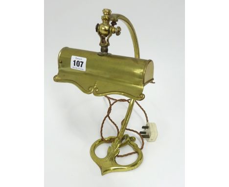A brass desk lamp of Art Nouveau design.
