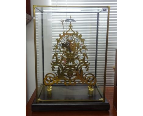 A large skeleton clock with cartouche enamel dial with roman numerals, bell strike, housed in a glass cabinet, overall height