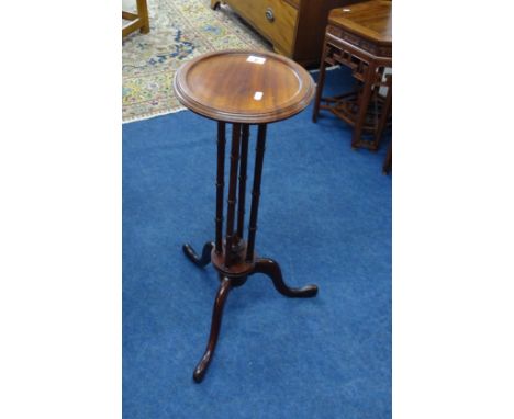 A reproduction mahogany tripod candle stand, height 66cm.