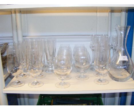 A collection of etched glassware, including a carafe, sherry, brandy, lager and champagne glasses 