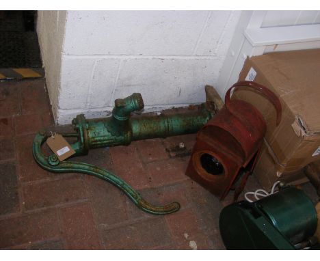 A vintage railway signalling lamp, together with old water pump