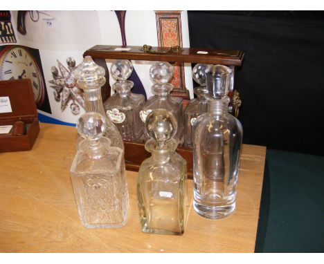A tantalus together with other glass decanters