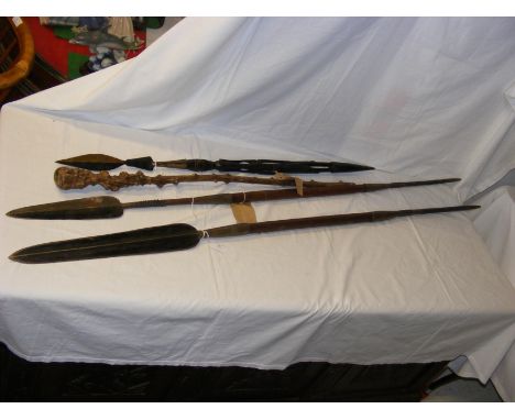 An antique African spear with wooden staff, together with two tother and an old African walking stick