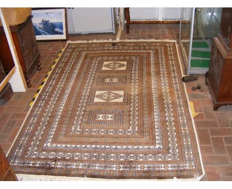 A Middle Eastern style carpet with geometric border - 240cm x 150cm