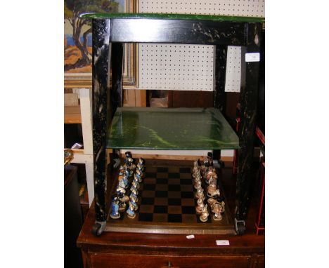 A two tier chess table and Alice in Wonderland chess pieces, together with an additional chess board