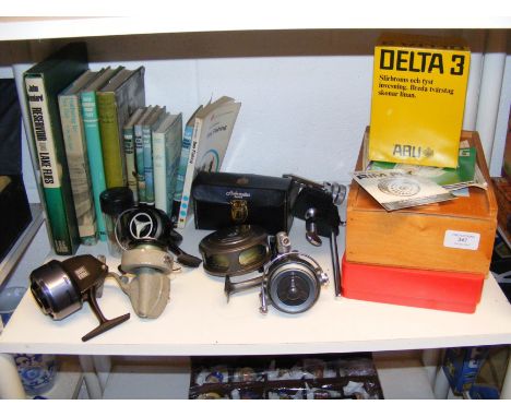 Assorted fishing reels, books and other related materials 