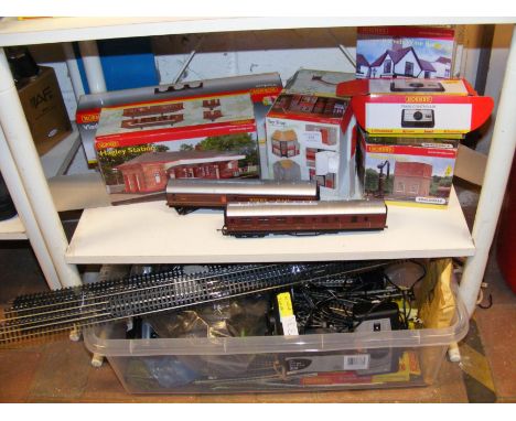 Hornby 00 gauge track and carriages, together with model buildings for train layout - on two shelves 