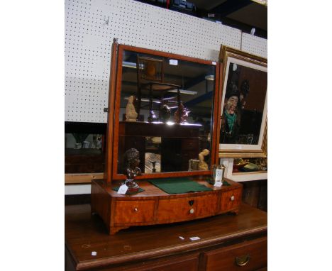 An antique toilet mirror with three drawers to the front