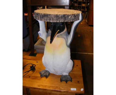 A novelty side table/plantstand in the form of a Penguin holding a tree trunk ring - diameter 32cm 