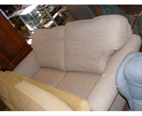 A contemporary two seater sofa upholstered in biscuit fabric - length approx. 180cm