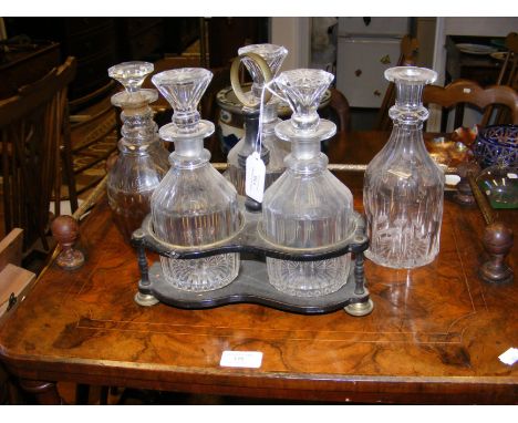 A three bottle tantalus, together with two other decanters