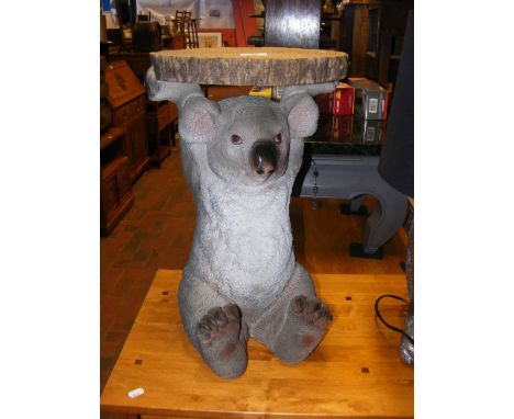 A novelty side table/plantstand in the form of a Koala Bear holding a tree trunk ring - diameter 32cm 