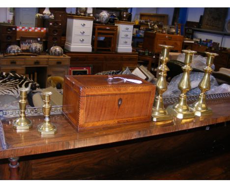 An antique two compartment tea caddy together with five brass candlesticks