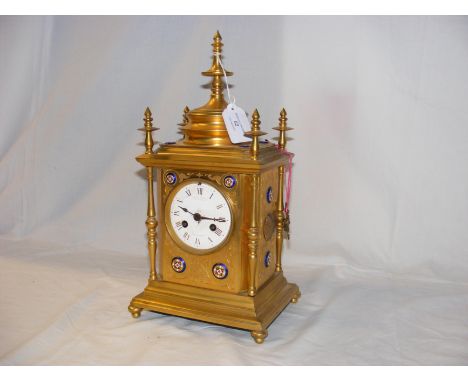 A decorative ormolu French mantel clock by Howell James and Co. to the Queen, having decorative cabochon mounts - 35cm high 