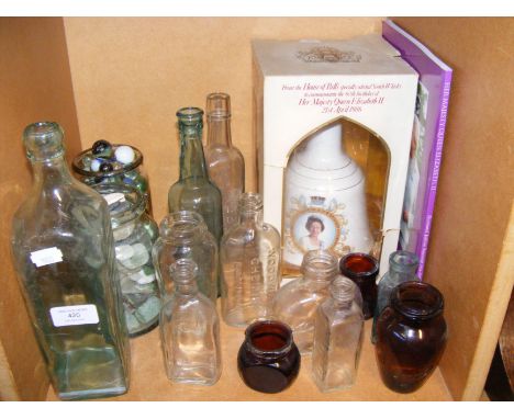 Vintage glass bottles, marbles and beach glass, together with ceramic commemorative bell 