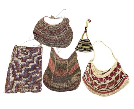 Four Melanesian Highland woven bilums and an unpainted tapa cloth (5).