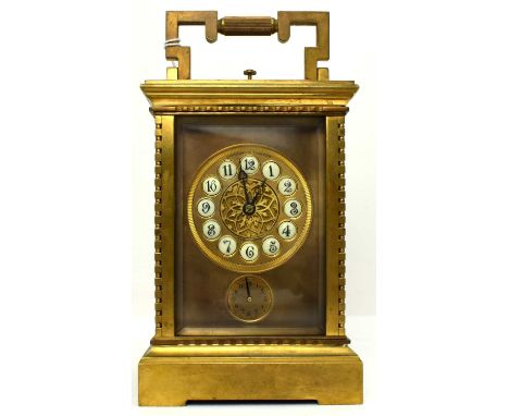 A 20th century gilt brass carriage clock, with push button repeat and alarm, the gilt metal dial with central open rosette an