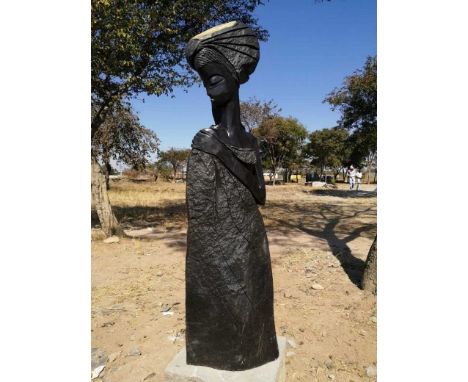 An African carved springstone figure of lady in headdress, height 125cm.Footnote: Buyers please be wear that this item is inc