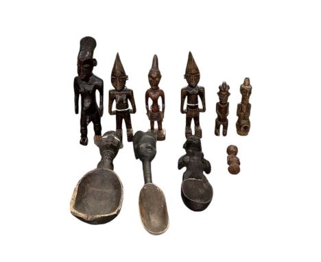 A collection of six African carved wooden figures including a Mangbetu figure, also three Yoruba Ibeji wooden spoons, all sur