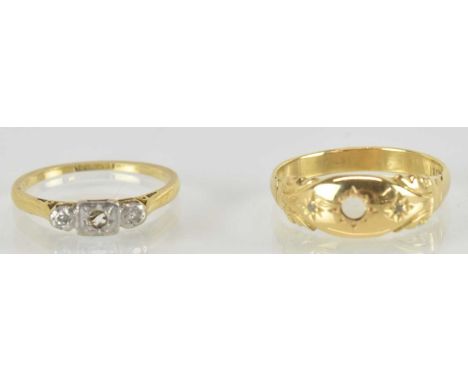 Two 18ct gold rings, the largest with missing stone flanked by two star set tiny diamond chips, size Q, the other with platin