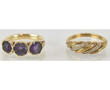 A 9ct yellow gold amethyst set three stone ring, the central amethyst approx 0.75ct, flanked by pair of amethysts, both appro