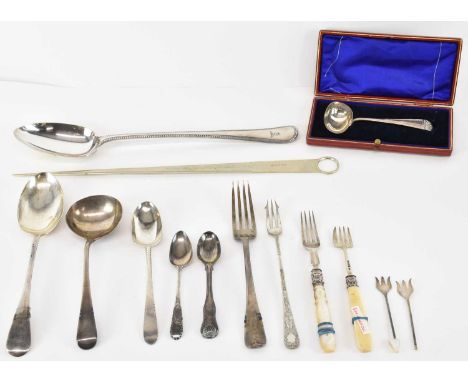 A group of hallmarked silver comprising a cased silver baby feeding spoon, a ladle, two teaspoons and two further spoons, fiv