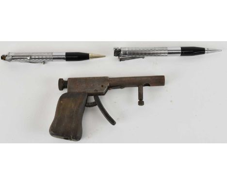 RONSON; two propelling pencil lighters, both length 14cm, and a further novelty lighter modelled as a pistol (3). 