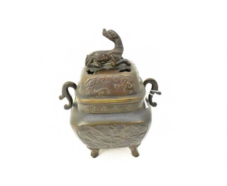 A 20th century patinated bronze koro of square shape, with pierced lid decorated with Japanese animal, possibly a dog, with s