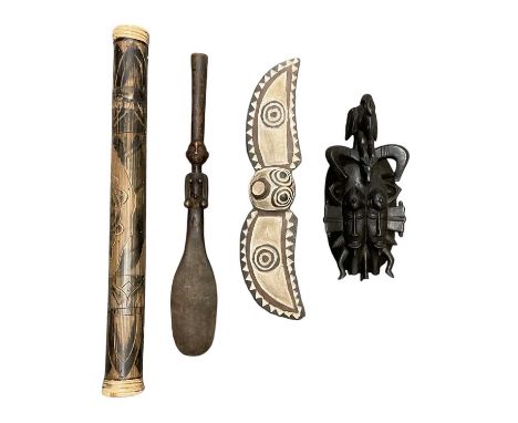 An African carved wooden male figure, height 53cm, a rain maker, length 60cm, a carved wooden double faced mask, surmounted w
