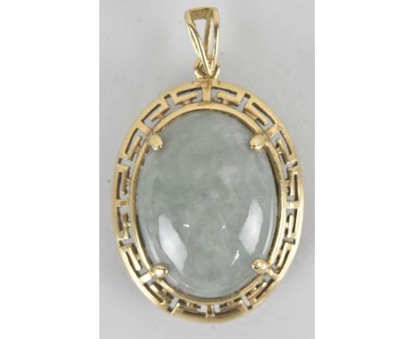 A half jade cabochon claw set in a 9ct gold Greek key mount, length 2.5cm.