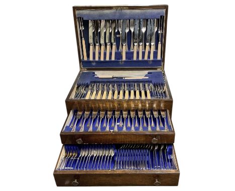An oak cased canteen of cutlery containing at least one hundred and forty pieces, with lift-up lid section over two pull-out 