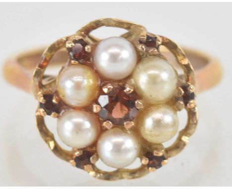 A 9ct yellow gold seed pearl and garnet set flower head ring, size M, approx 3.9g.