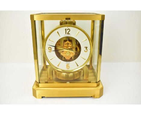 JAEGER-LECOULTRE; a gilt brass Atmos VIII clock, with brass framed glass panel, white chapter ring with Roman numerals, in fi