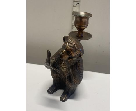 A novelty brass candlestick in the form of a monkey. 