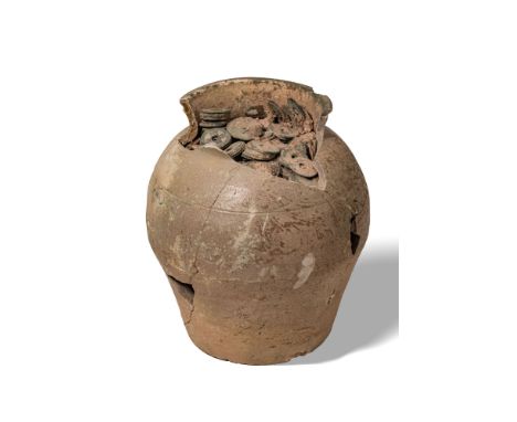 Song Dynasty, Ca. AD 960 - 1279. An earthenware storage jar containing a dense cache of Chinese bronze coins. The globular ve