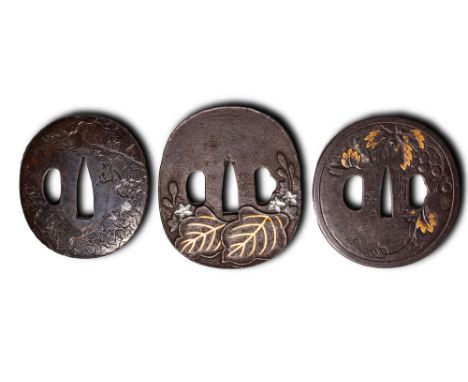 Edo Period, Ca. AD 1603 - 1868. A set comprising a tsuba finely chiselled in low relief with a landscape scene of an immortal