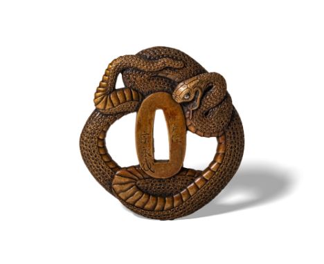 Edo Period, Ca. AD 1603 - 1868. An iron tsuba skillfully formed in the shape of a coiled snake. The serpent wraps sinuously a