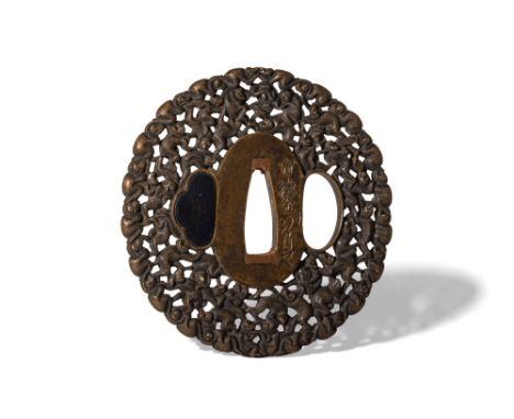 Edo Period, Ca. AD 1603 - 1868. An iron sukashi tsuba intricately pierced and carved in openwork with a continuous design of 