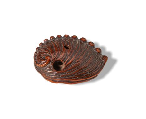 Ca. AD 1850. A finely carved wood netsuke in the form of an abalone shell, detailed with naturalistic ridges and textures, si