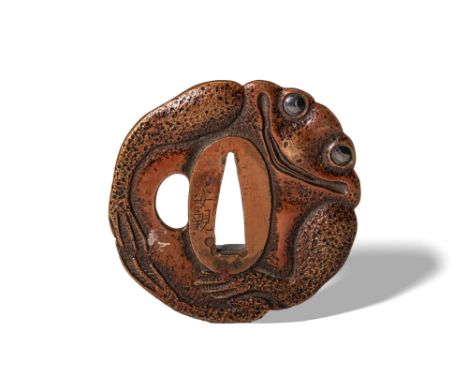 Edo Period, Ca. AD 1603 - 1868. A tsuba boldly cast in the naturalistic shape of a frog, its body textured to mimic the mottl