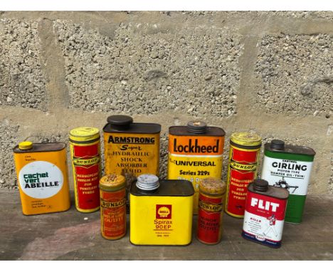 A selection of assorted oil cans including Shell, plus four Dunlop puncture repair kit tins.